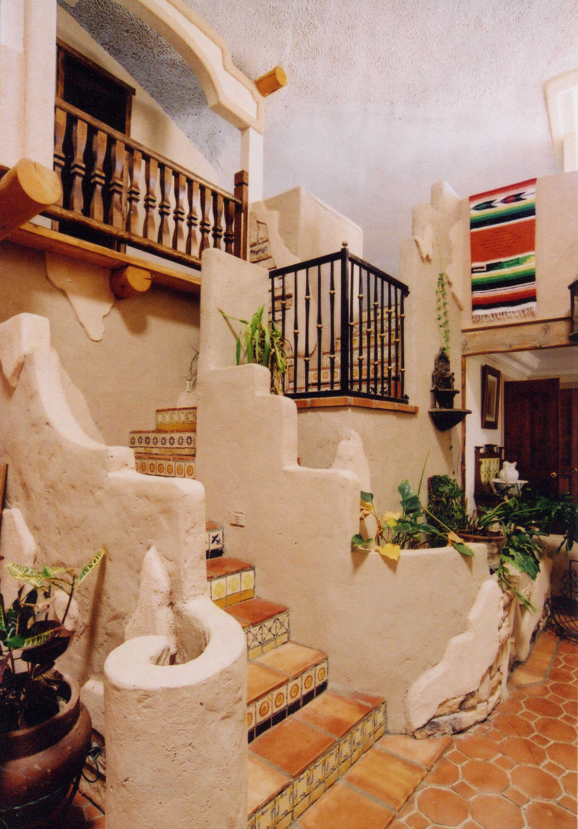 Stairway — Its Mosaic tiles lead to the upper level living areas.