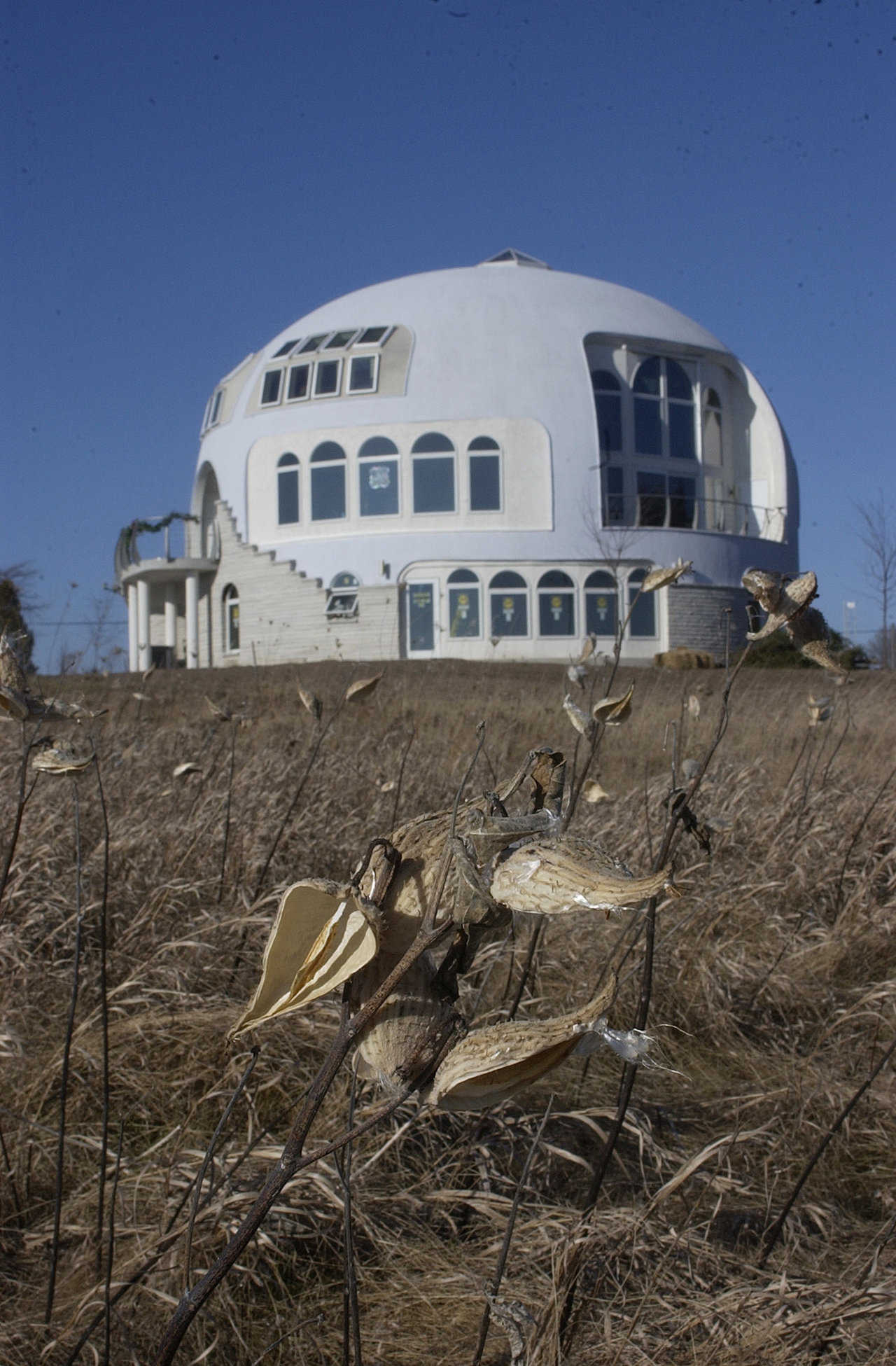 The Disappearing Dome — This dream-come-true home in Manitowoc, Wisconsin is a Monolithic Dome with a diameter of 55 feet and three stories. It overlooks Lake Michigan and on foggy days because almost invisible.