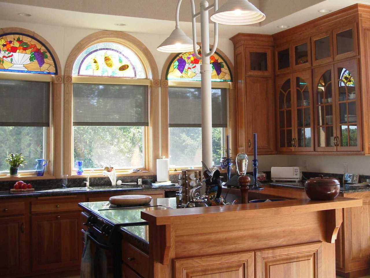Gourmet Fittings — The kitchen features custom cabinets and stained-glass windows.