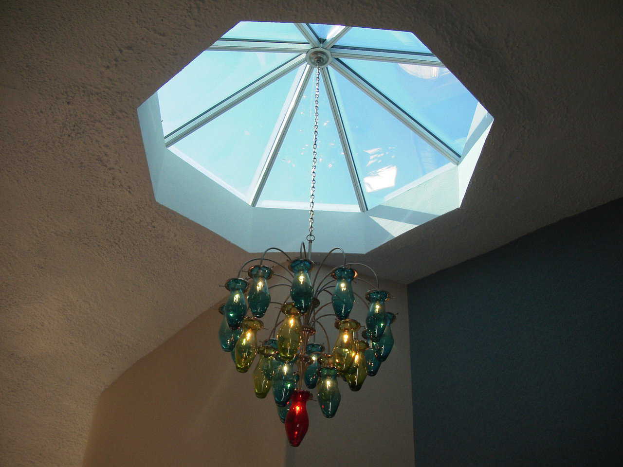 Unique Touches — A beautiful, glass chandelier hangs from a skylight.