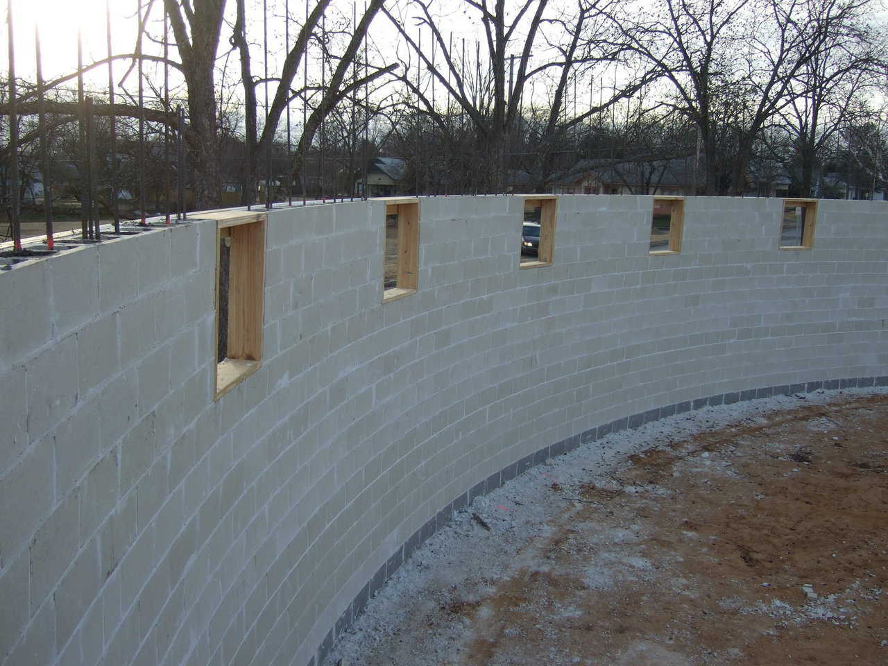The stem wall is now complete. The crews will now form and pour a concrete ring beam on top of the walls. This beam is where the Airform will be attached.