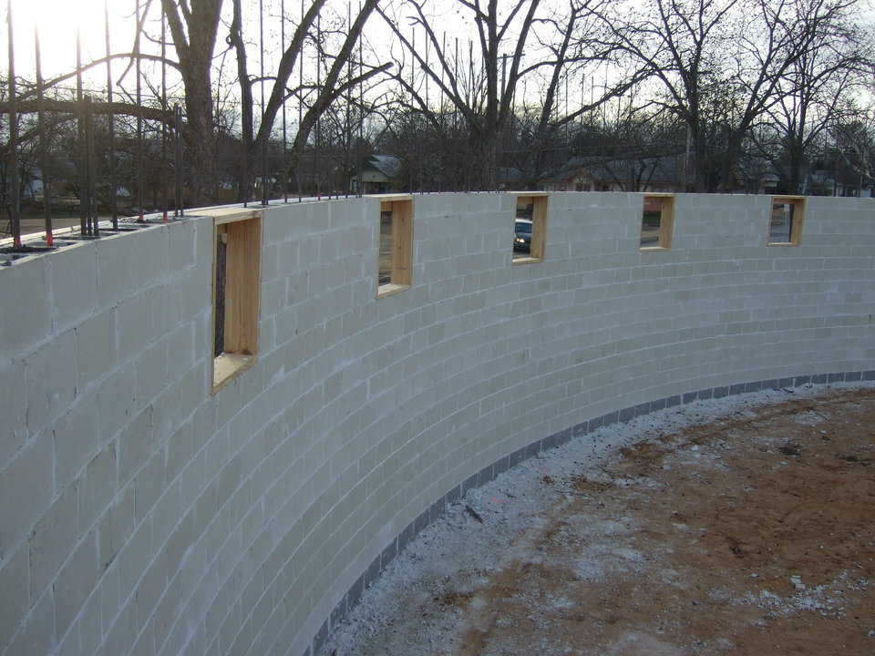 The stem wall is now complete. The crews will now form and pour a concrete ring beam on top of the walls. This beam is where the Airform will be attached.