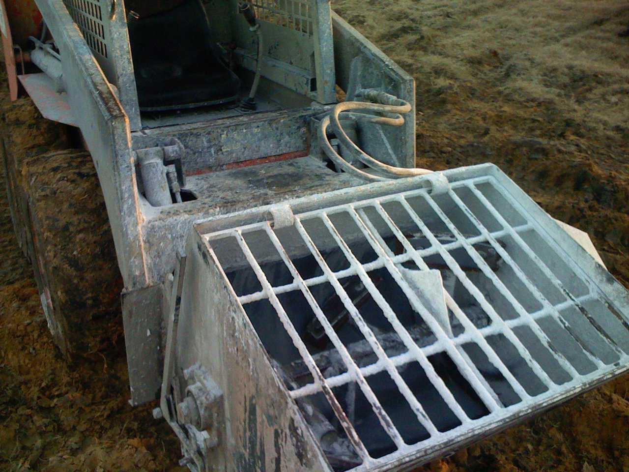 Inside the Monolithic Concrete / Mortar mixer. It’s auxiliary hydraulics are compatible with nearly every skid steer on the market, in fact we have never come across one that it wouldn’t fit.