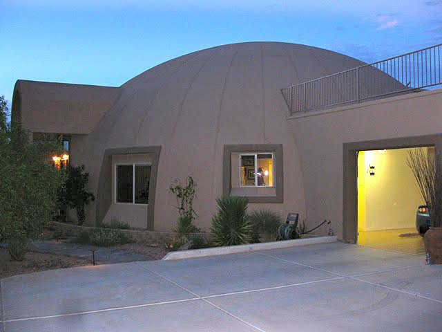 Garage – A rectangular, stucco 4-car garage is attached to the dome-home.