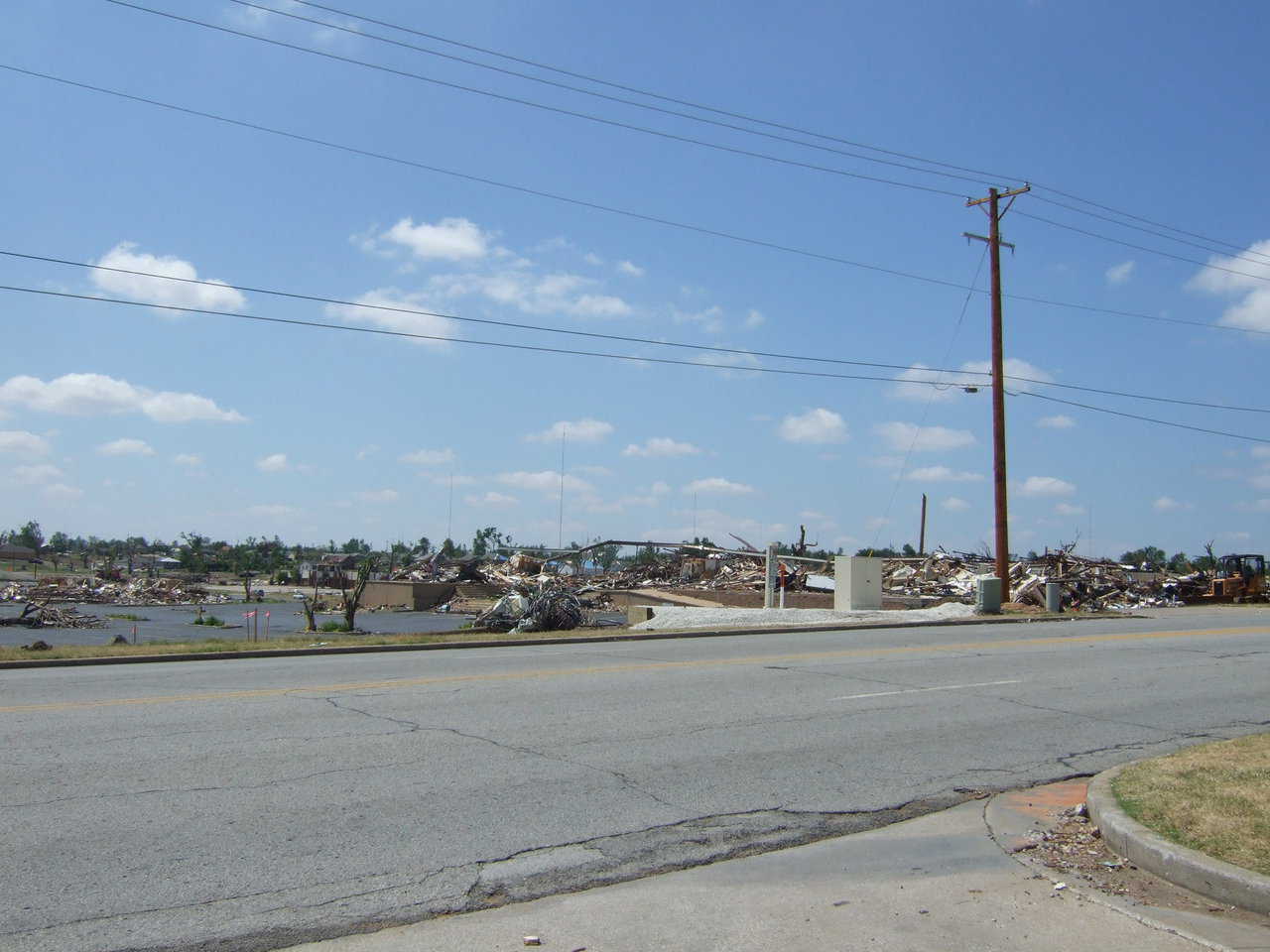 Total destruction. Structures flattened. Trees uprooted. Much debris everywhere.