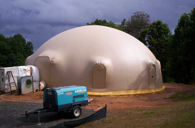 The Ecker dome-home — after the Airform was inflated, its perimeter was sprayed with leftover, two-part, closed cell foam. It’s clearly visible as a bright yellow band along the foundation.