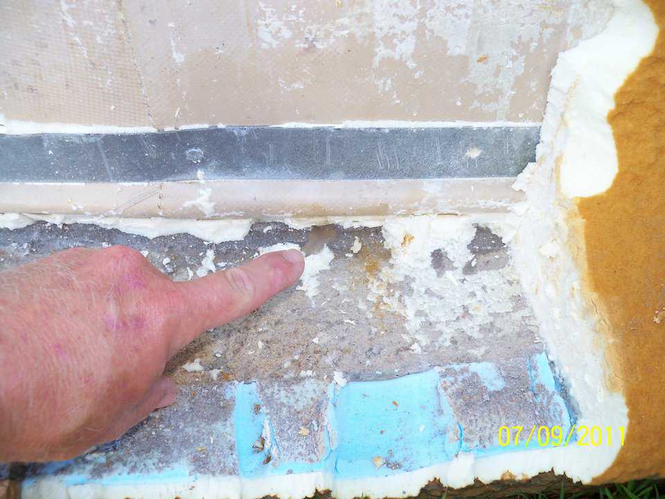 A puddle — here a small puddle of water drips out from behind the Airform rope. There was a small void behind the Airform and above the strapping where the foundation ring crowned outward along the highest border. Note the proximity of the seam to the puddle.