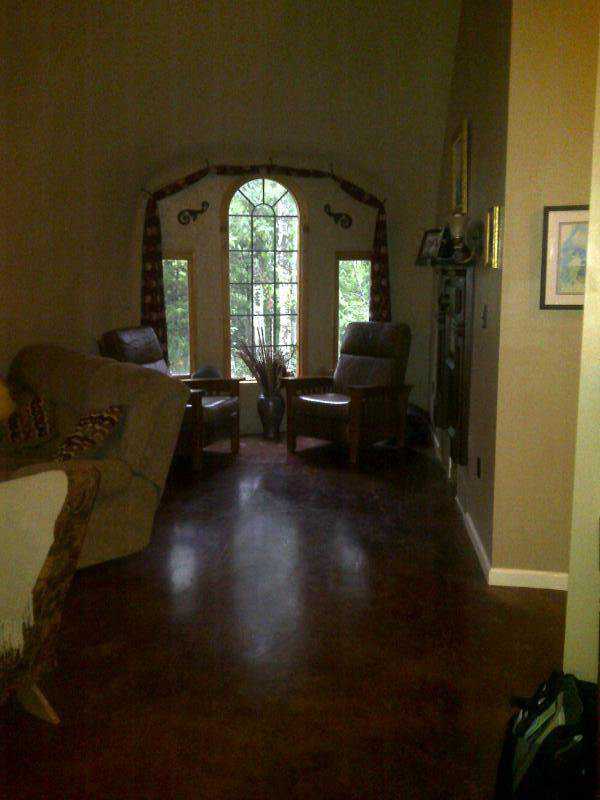 The living room includes comfortable seating at a window with a nice view.