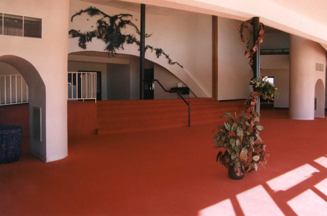 The main entrance to the sanctuary is up a short flight of steps from the foyer through the arched opening.
