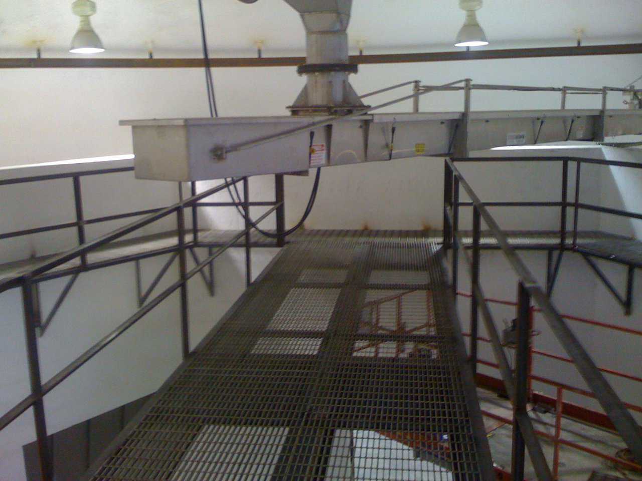Taken from the catwalk — Its showing the rear portion of the rotating conveyor. It also shows the rail.  It’s hung from the dome that supports the far end of the rotating conveyor.  You can see across the bin wall into the bins.