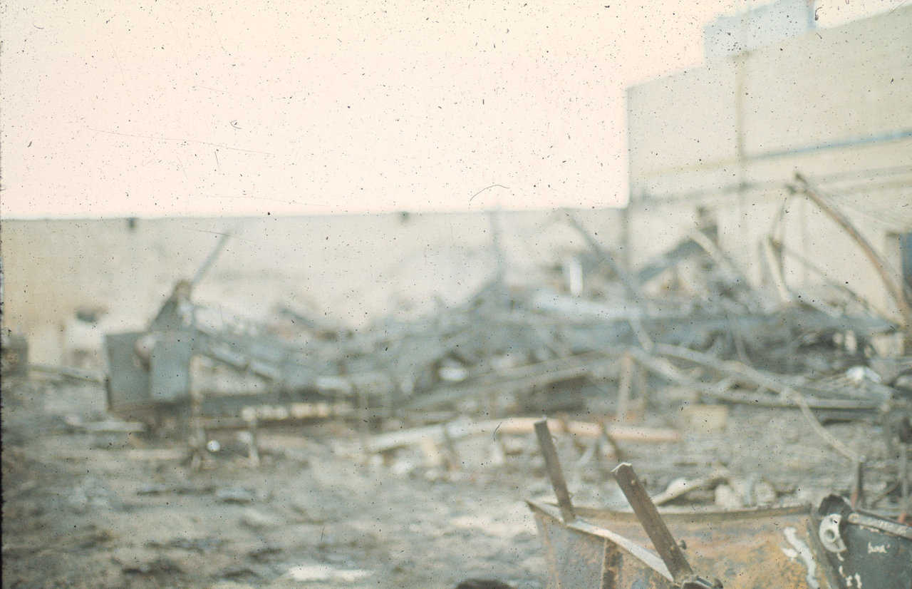 Initial flashover of this fire set the wooden roof on fire.
Fuel provided by the roof was enough to burn off the urethane foam. Foam used on this structure was UL rated under 25 flame spread. It needed the extra fuel of the roof to burn off the foam. Note how the fire mangled all of the equipment within the sorting and bagging area.