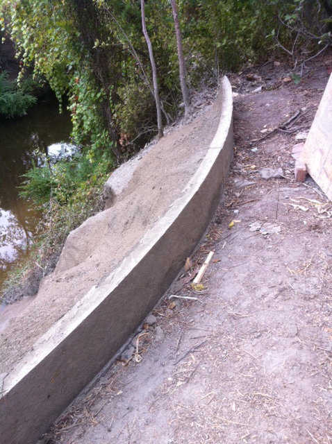 We have the top looking down the slope all done. The top wall is done, except for a bit of grouting to clean the vertical surface.