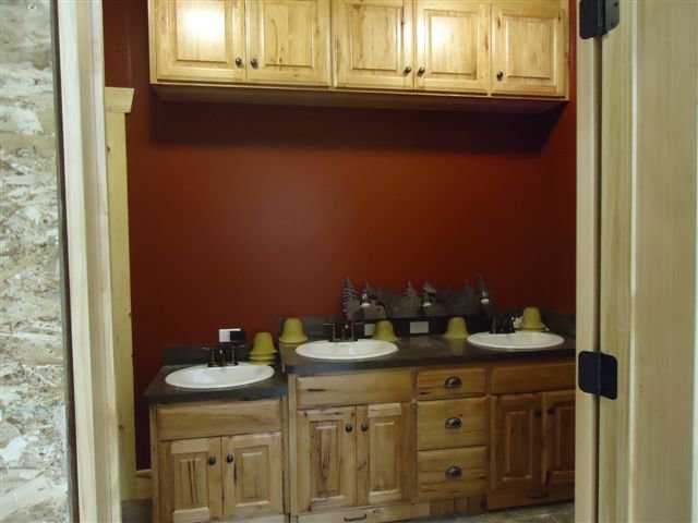 In addition to three sinks, this bathroom (one of seven) has lovely wood cabinets.
