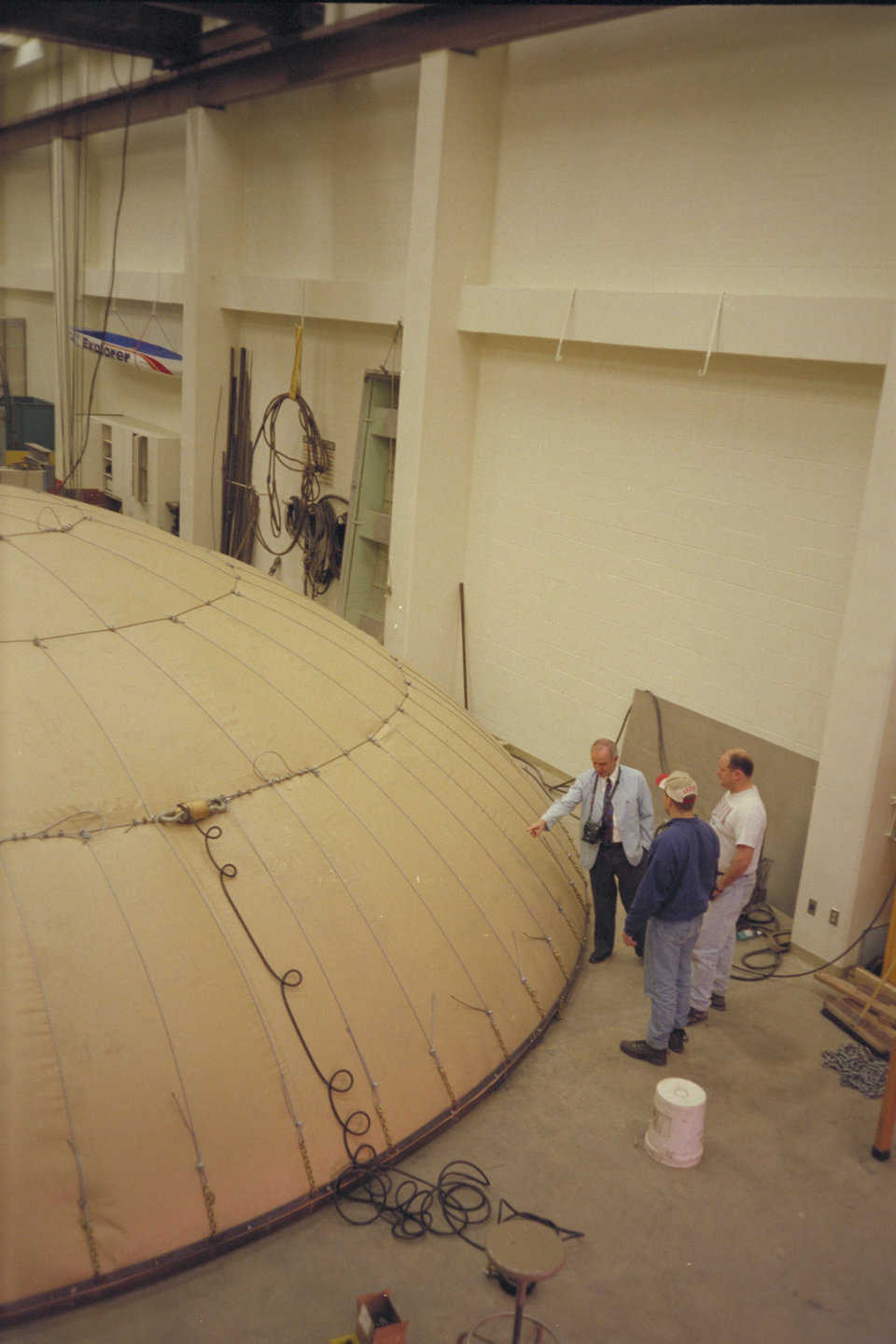 Dr. Wilson and two students examine the Crenosphere test model. A Monolithic Dome built without cables may be built to 296’ in diameter. This test showed that a cable restrained dome may achieve domes up to 1000’ in diameter.