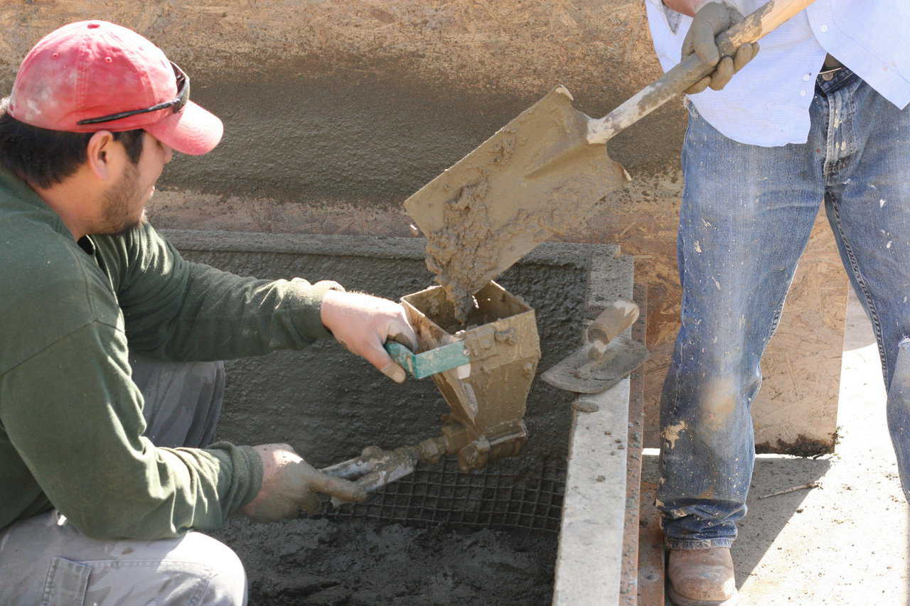 Loading the Quickshot is easy. You can load it by shovel, as pictured here, or by scooping the concrete directly out of the mixer, as depicted in the next image.