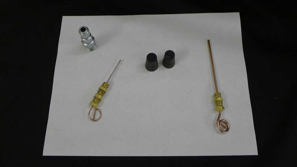 Accessories: These are some of the accessories that come with the Three Hole Model. They include three large jets, three small jets, two hole plugs, and one large air adapter. The large air adapter is important because you need as much air as possible for a good spray.
