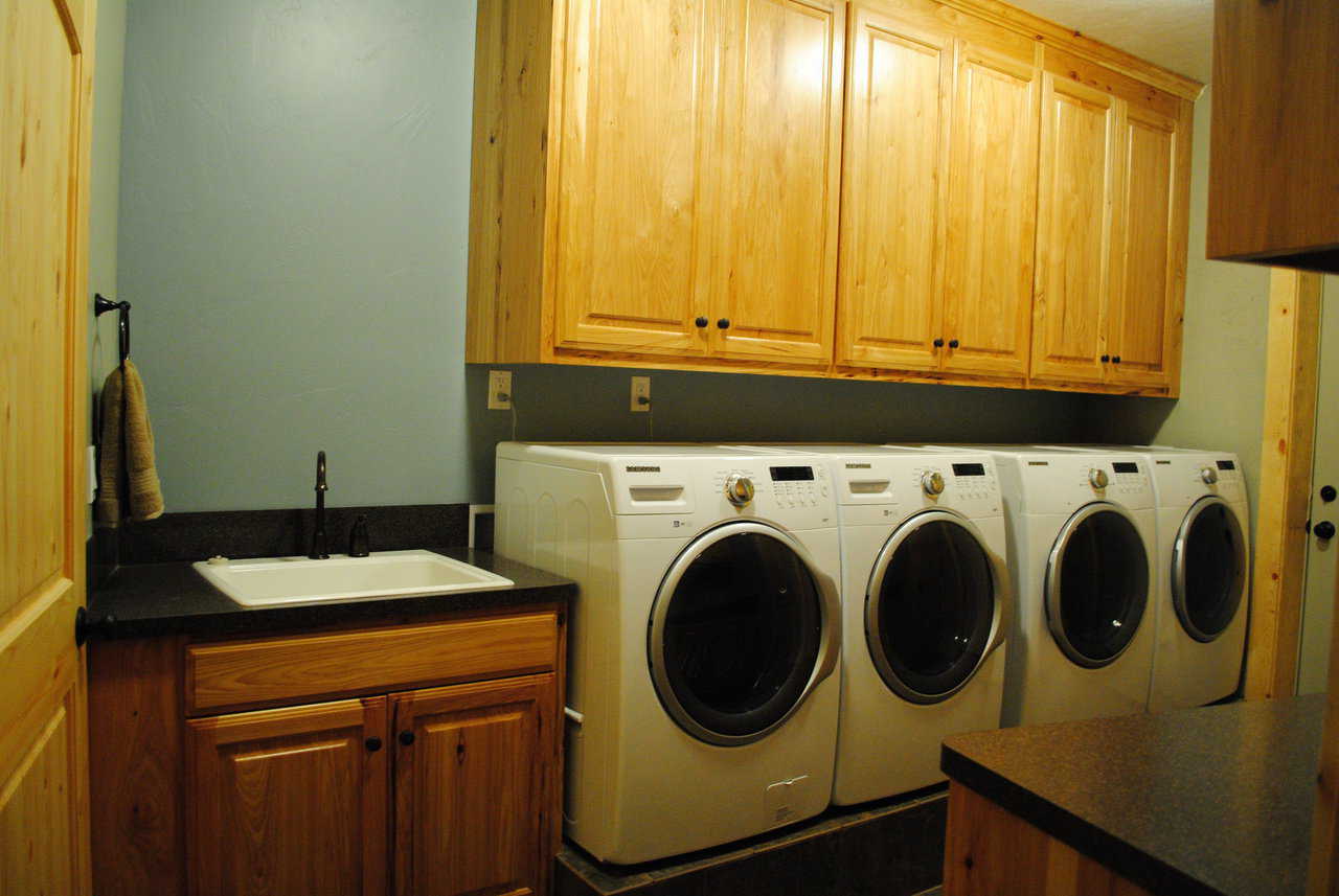 The laundry area includes multiple washers and dryers.