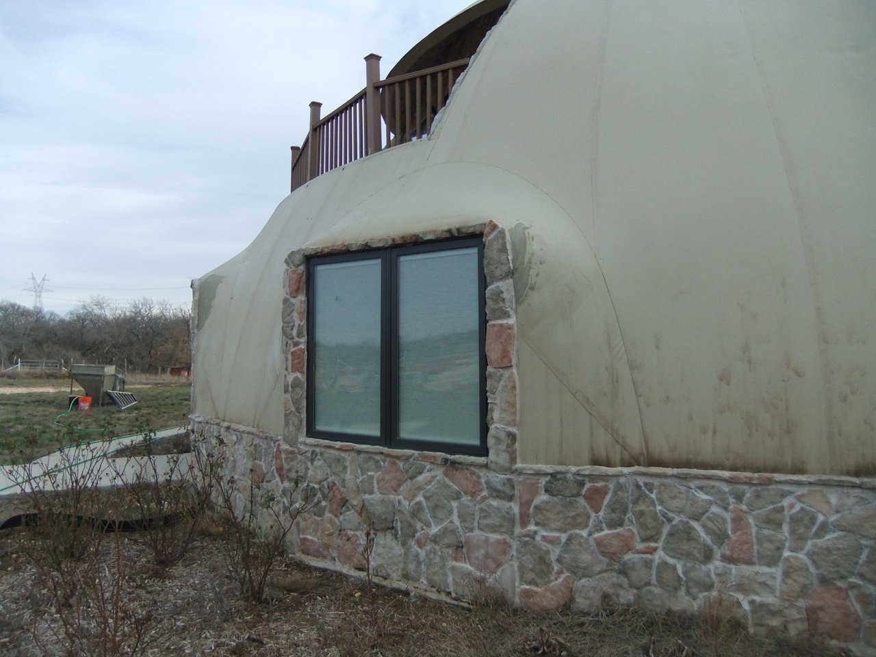This is the dome as it stood when Monolithic arrived.  The top corners of the windows had wrinkles that we flattened before applying the stucco.