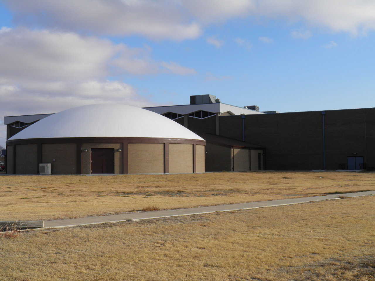 This dome is encased in brick that complements the brick on nearby buildings.