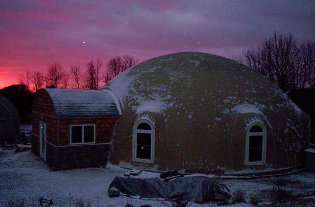 Serenity Dome, a Callisto-style 2/5 oblate ellipse. It has a diameter of 50 ft, 28,700+ cubic feet, 2675 ft2 of floor area, and 103 yds3 of concrete in the shell and floor for thermal battery. According to Chris, "Serenity Dome uses about 1/3 the energy of our previous brick-and-stick built home in Virginia Beach. It’s tough to find an investment like a Monolithic Dome!