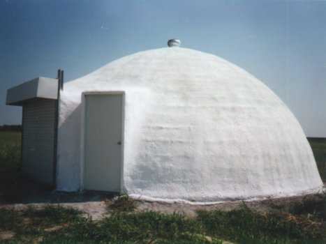 Shown here is an Ecoshell with a 20’ diameter. It’s one of the first ones we built as a commercial building. Notice that it is spherical in shape. Made as an Ecoshell I, it was built during a Monolithic Workshop, here at our plant in Italy, Texas. It is about 20 years old and has worked very well for us. The structure was painted with a white exterior coating.