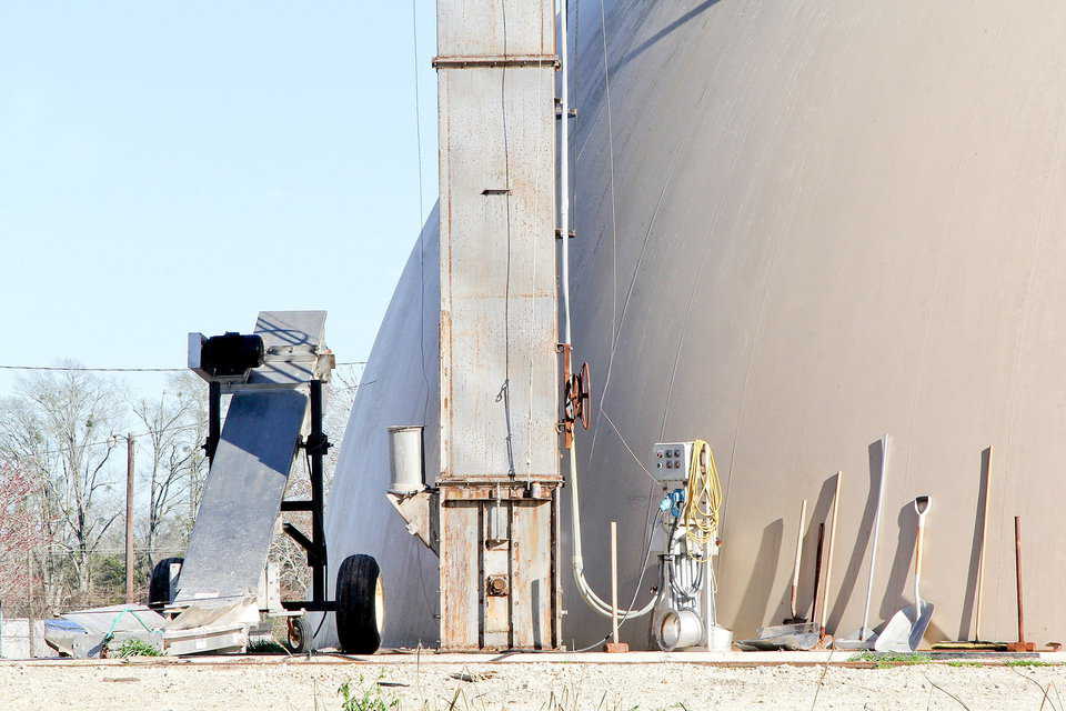 This Monolithic Dome fertilizer blend plant is equipped with an elevator. A control panel sits close to the elevator base.