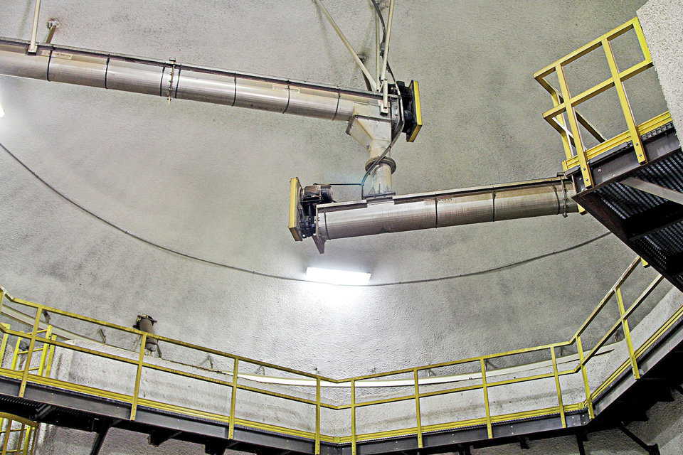 Pictured here is the rotating distribution conveyor. The top conveyor brings material from the outside elevators, drops it into the rotating conveyor, then delivers it to a specified bin.