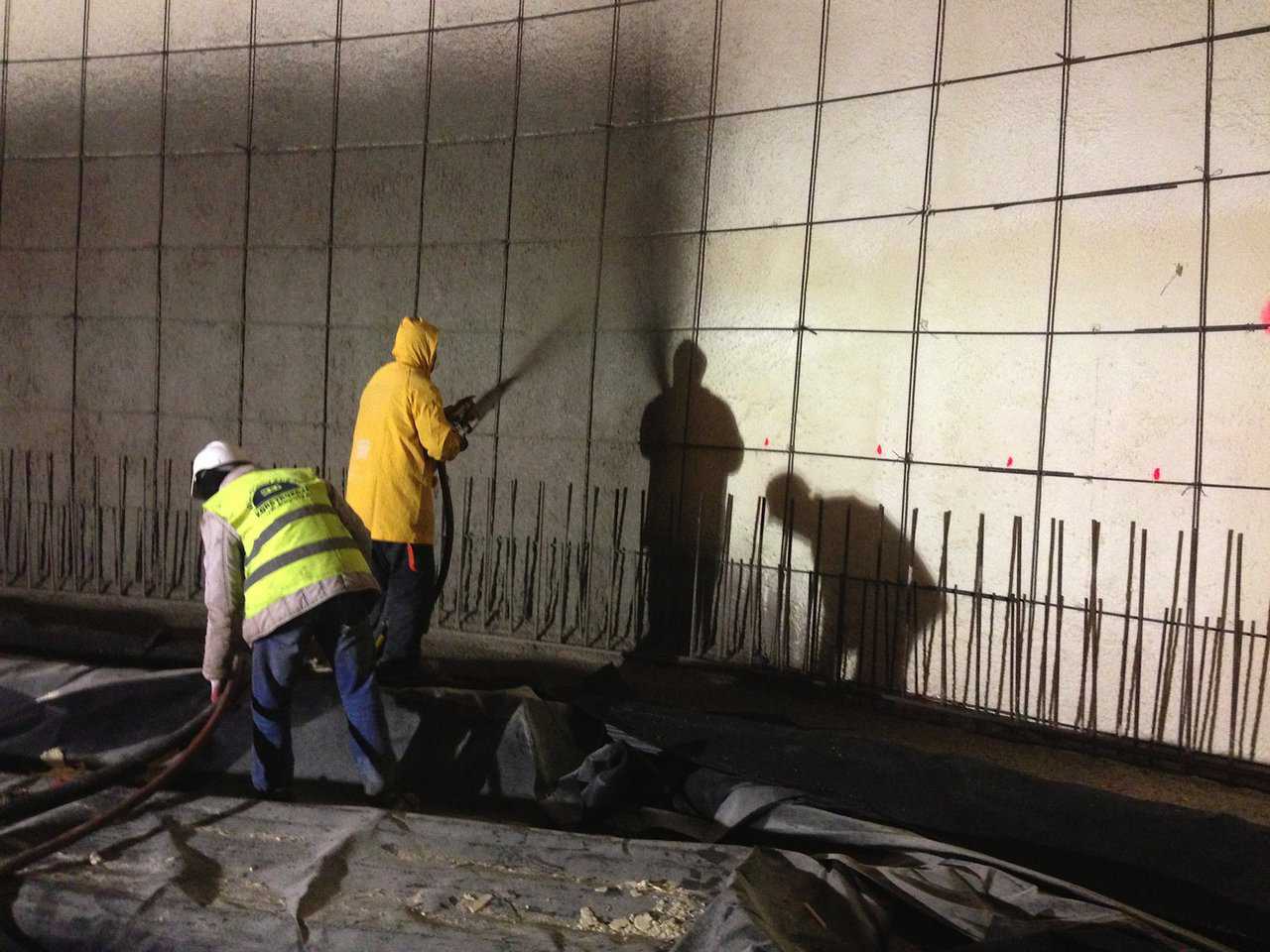 Initial shotcrete is sprayed to embed the pre-mat.