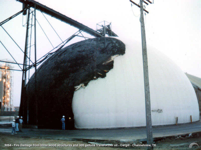 This damage was caused by a huge explosion of 300 gallons of transformer oil. The oil burned for nearly an hour with winds of up to fifty miles per hour blowing it directly against the dome. The two wood buildings that were attached to the dome were completely incinerated.
This happened in the middle of the night. Fire crews didn’t appear on the scene until after the fire had burned itself out.
The contents inside the dome were completely unharmed. The ambient and wall temperatures only rose a tiny amount. Fire damage to the dome was cosmetic. (1996)