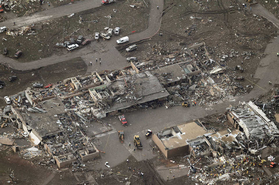 An aerial photo showing damage to Plaza Towers Elementary School after it was hit by a massive tornado in Moore, on May 20, 2013. Rescue workers and a helicopter can be seen at lower right.