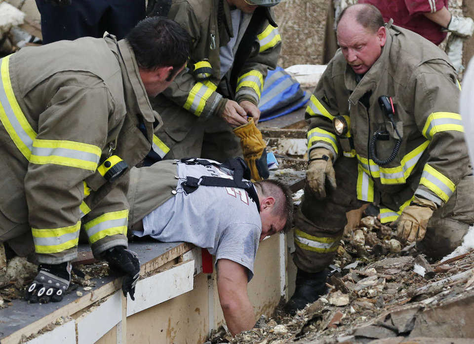 Rescue workers dig through the rubble of a collapsed wall at the Plaza Tower Elementary School to free trapped students in Moore, on May 20, 2013.