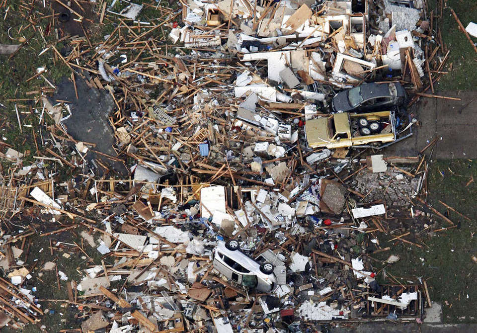 An aerial photo shows the remains of tornado-damaged houses in Moore, on May 20, 2013. A tornado roared through the Oklahoma City suburbs Monday, flattening entire neighborhoods, setting buildings on fire and landing a direct blow on an elementary school.