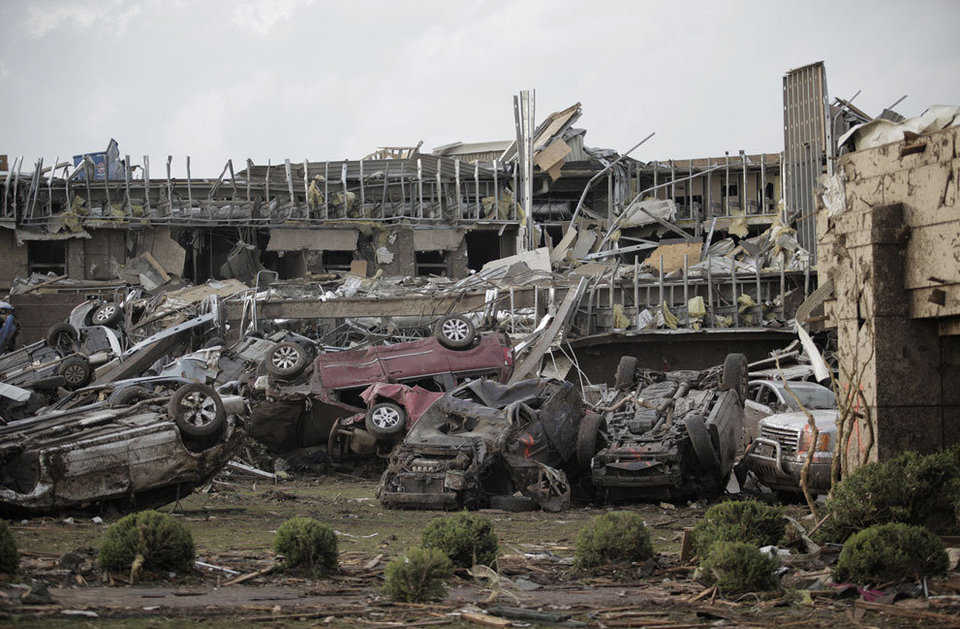 Flipped vehicles are piled up outside the heavily damaged Moore Medical Center on May 20, 2013.