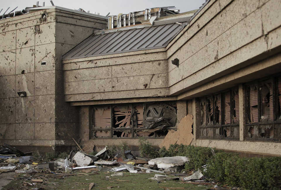 The hood of car is wedged into the front window of the Moore Medical Center after a powerful tornado ripped through the area on May 20, 2013.