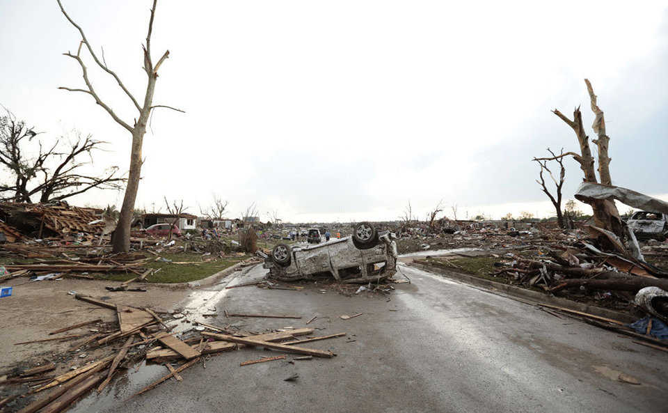 A vehicle lies upside down in the road after a powerful tornado ripped through the area on May 20, 2013 in Moore, Oklahoma.