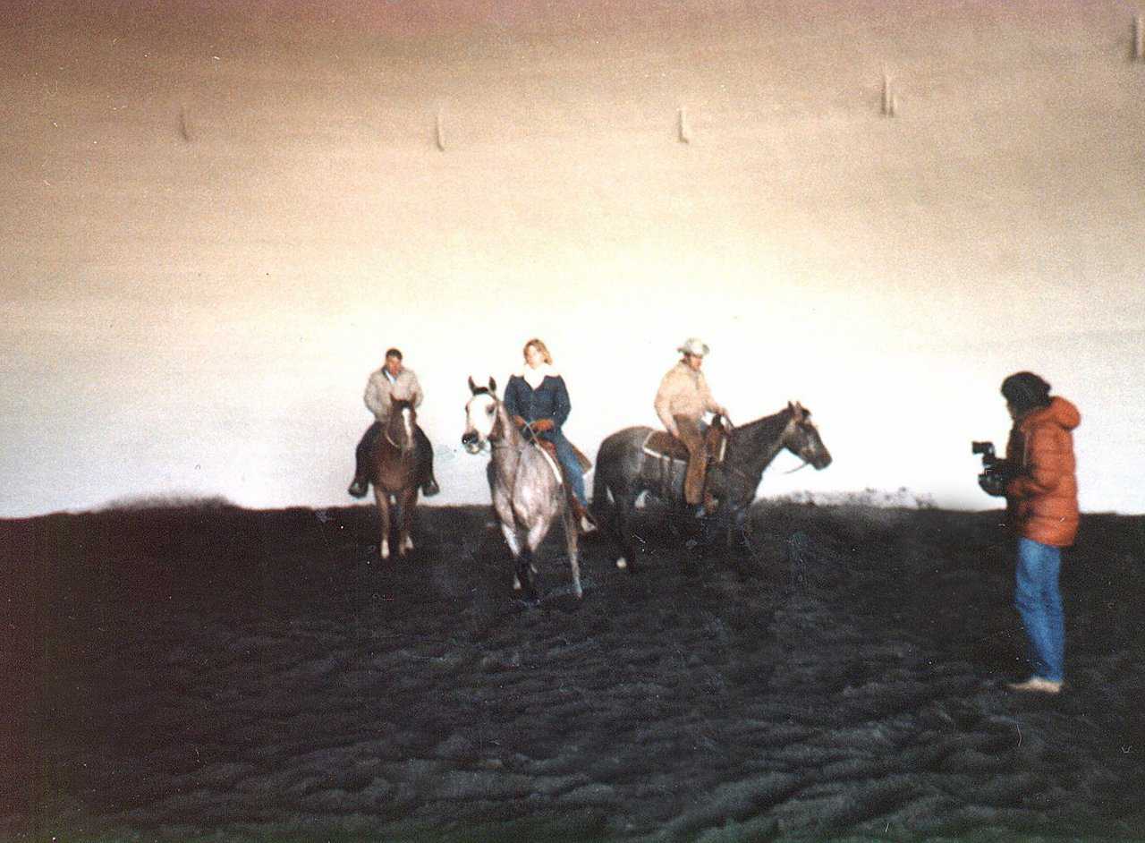 Riders workout some horses in a small arena in Idaho.