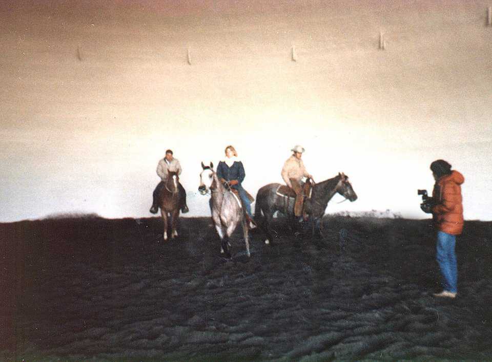 Riders workout some horses in a small arena in Idaho.