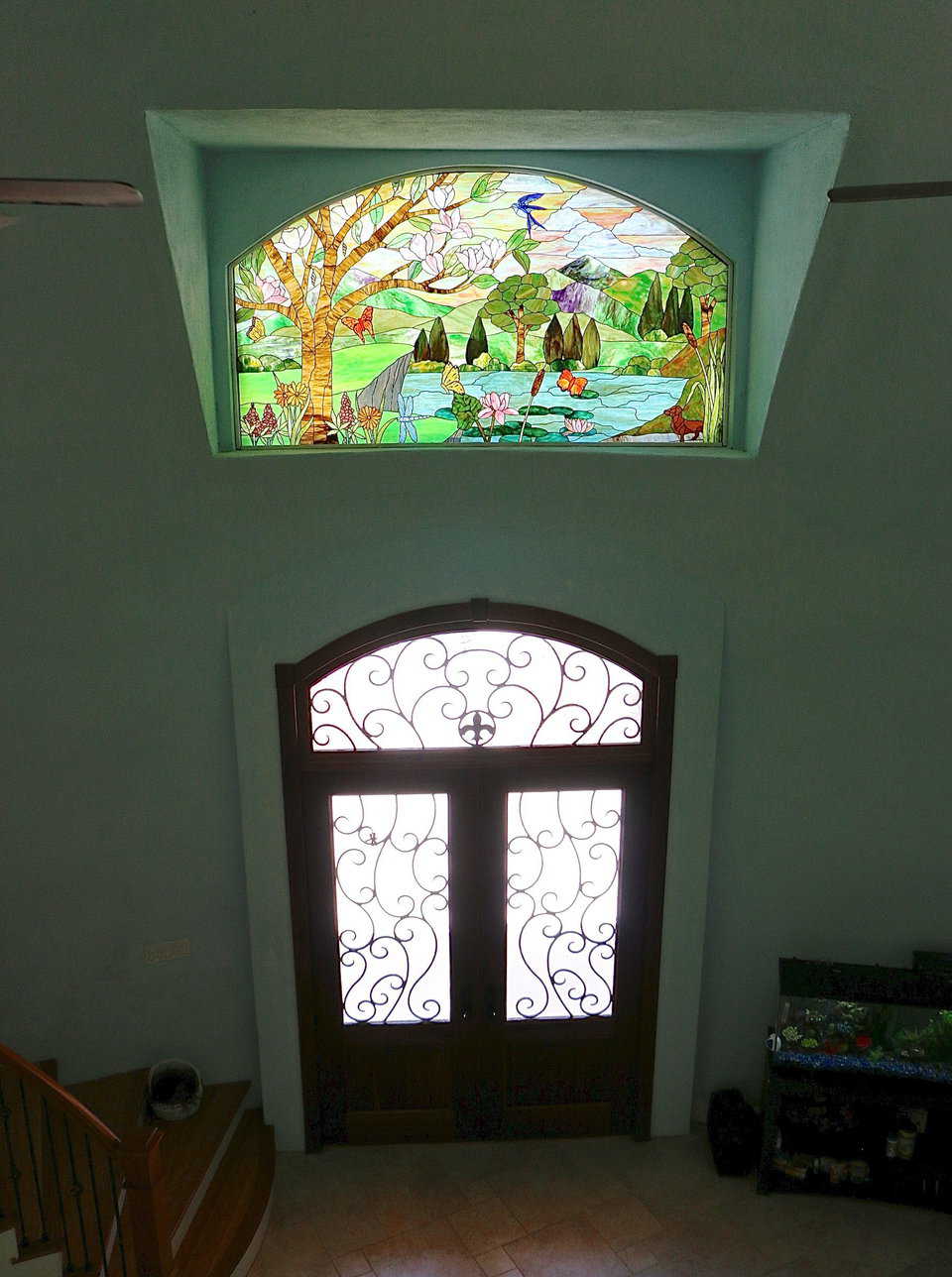 The stained glass window above the front door of the Monolithic Dome Home can be seen clearly from the second floor railing. This window was a gift from the Whiteacre’s children who designed it themselves. The details in the design have special meaning to the Whiteacre family.
