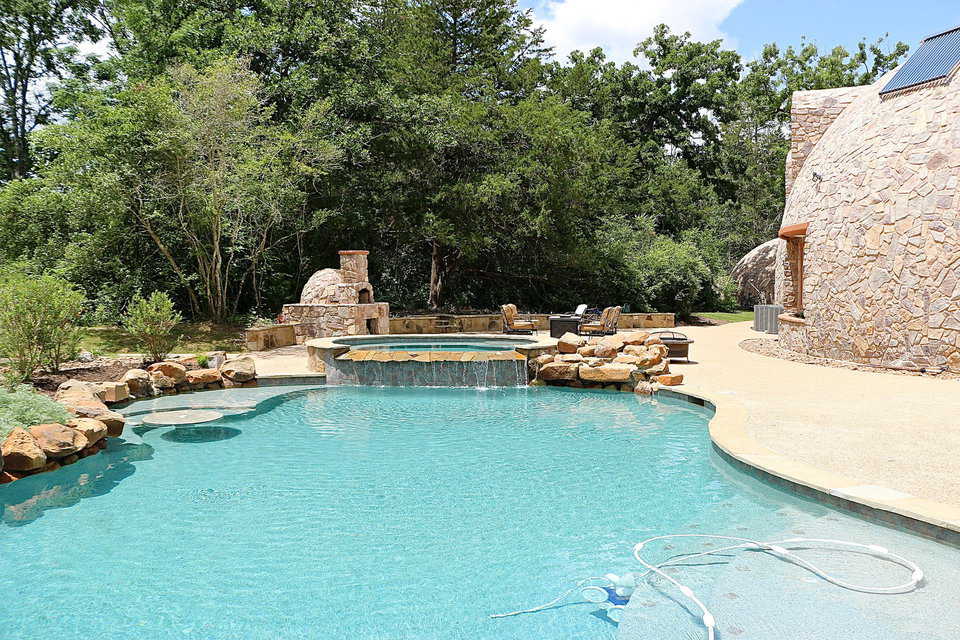 The stunning curves of the Whiteacre’s swimming pool with two waterfalls and a hot tub, are perfect in the backyard of their Monolithic Dome home.