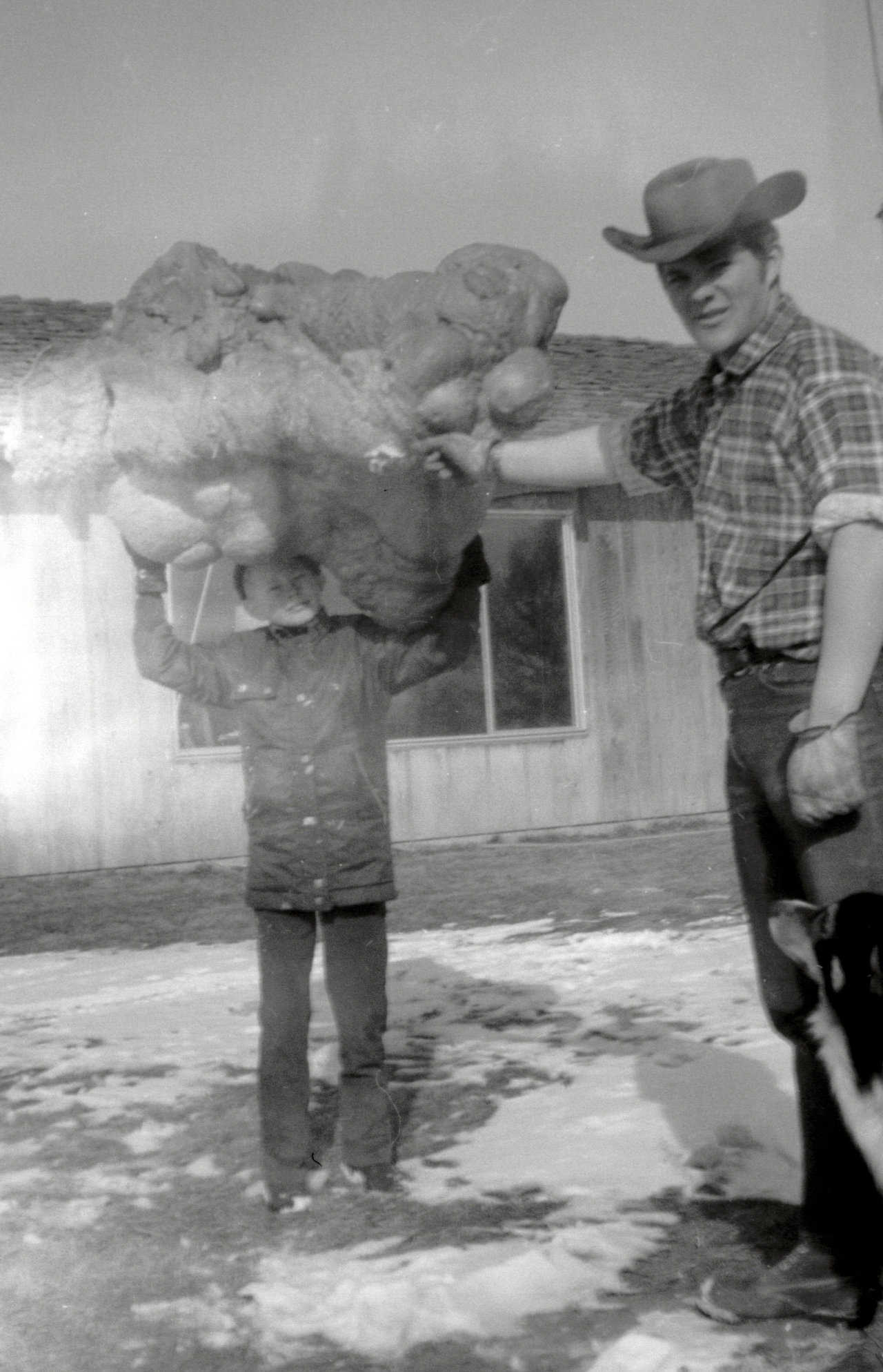 Barry Jones, David’s 10-year-old cousin, holding a polyurethane boulder above his head, steadied by Randy South. (Circa 1971)