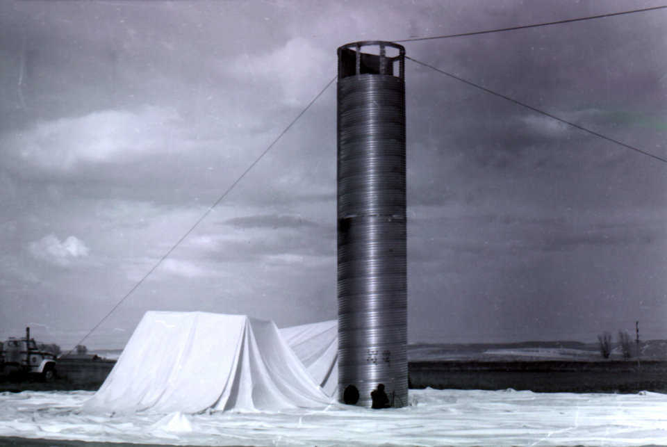 The construction of the first dome built by Monolithic. Pictured, is the air-formed membrane ready to inflate—the first step in Monolithic’s patented construction process. Shelley, Idaho – April 1976.