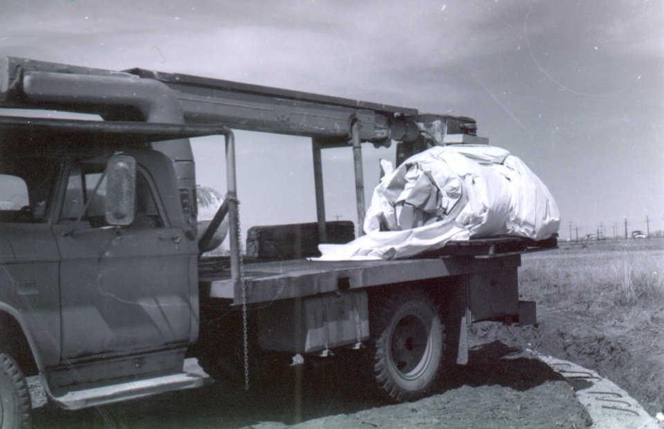 The fabric membrane arrives on site to be inflated for the potato cellar in Shelley, Idaho that will be the first dome ever built using Monolithic’s patented construction process. April 1976.