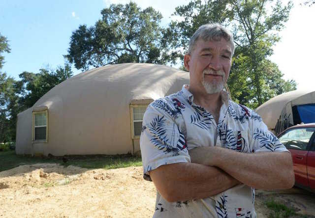 David Smith in front of his Monolithic Dome home near Orange, Texas.