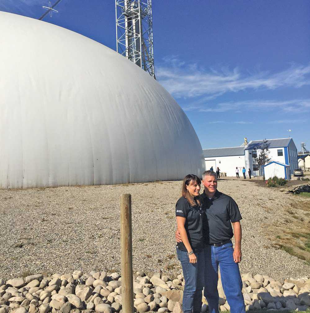 Christina and Andy Stender of Crowfoot Ag in front of their Monolithic Dome fertilizer blend plant.