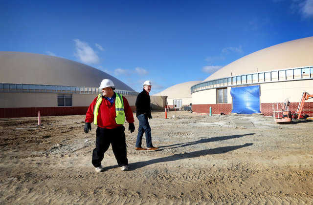 Superintendent Michael Garvey and Johnson Creek School Board president Rick Kaltenberg tour grounds of the new Monolithic Dome high school under construction.