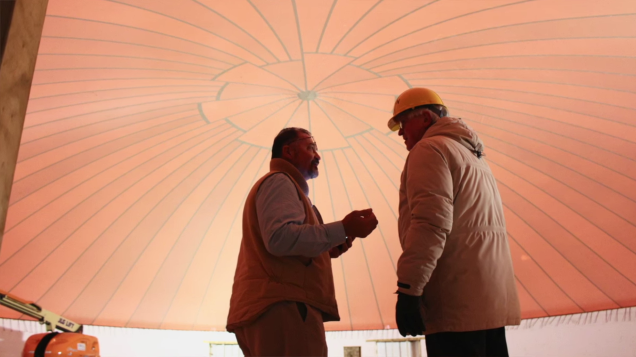 Kasson Public Library director Art Tiff (right) discussing the new library with local patron.