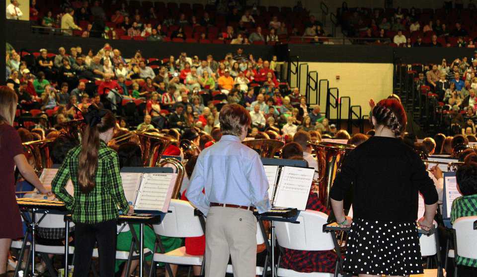 Sixth grade band performing for parents and friends. Audience seating extends for stage performances.