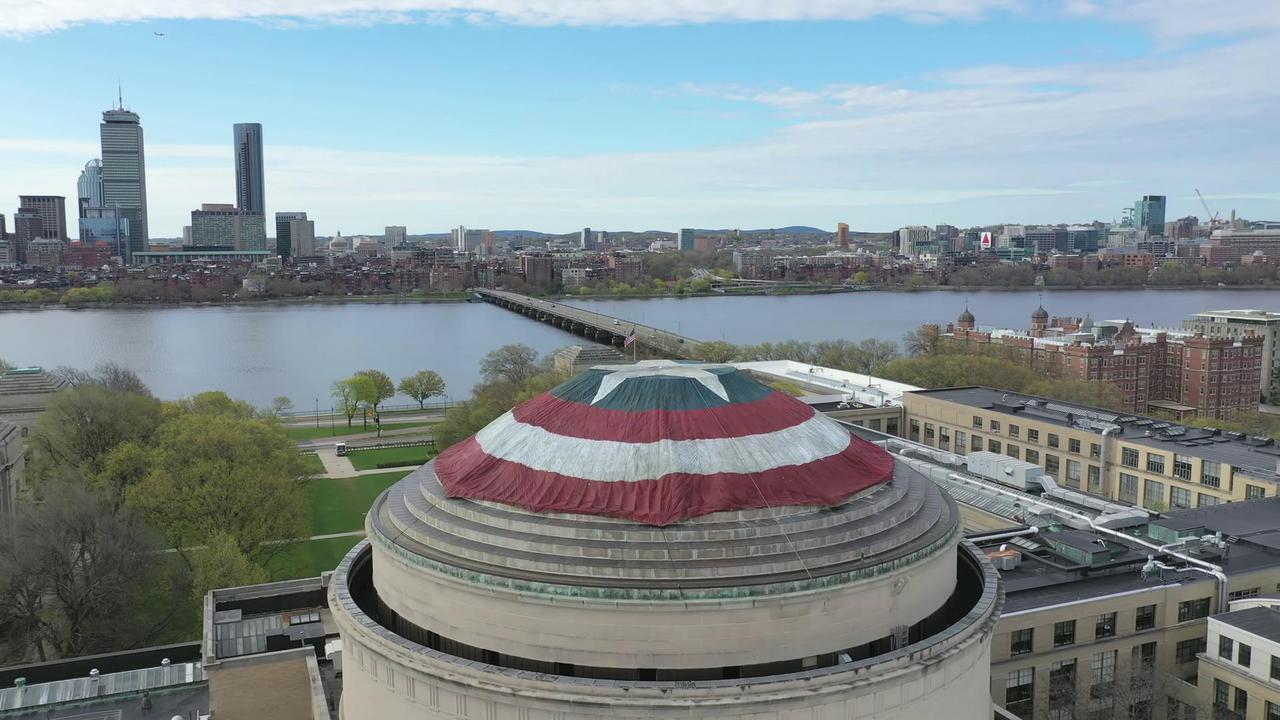 Side view of shield with river and city behind