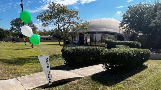 Open house sign and balloons in front of the office